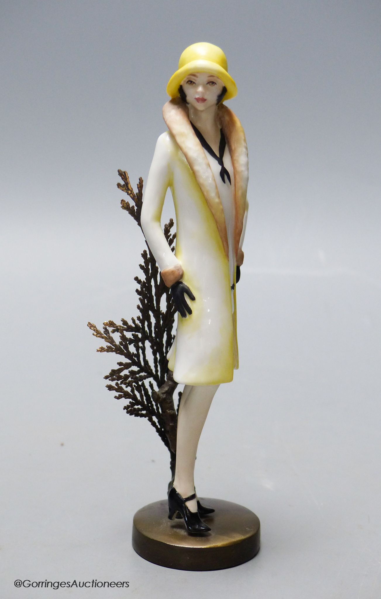 An Albany Worceter Art Deco style bronze and porcelain model of a young woman